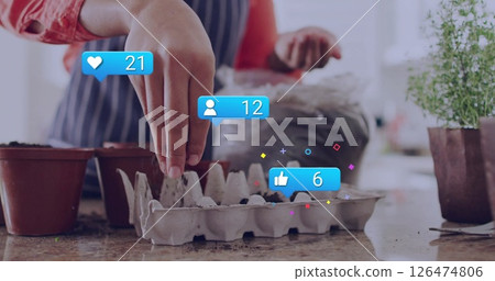 Planting seeds in pots, social media notifications image over gardening activity Planting seeds in pots, social media notifications image over gardening activity 126474806