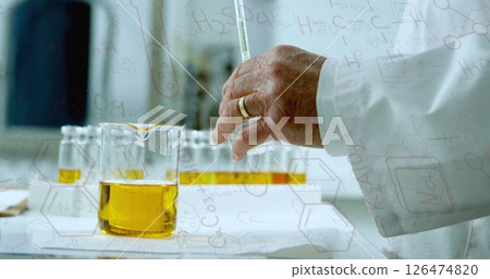 Pouring liquid into beaker, scientist working in lab with chemical formulas image Pouring liquid into beaker, scientist working in lab with chemical formulas image 126474820