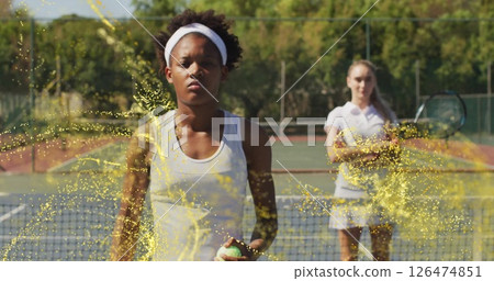 Playing tennis, women surrounded by golden particles image on court Playing tennis, women surrounded by golden particles image on court 126474851