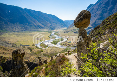 View of Chulyshman valley and river through stone mushrooms in Altai Russia Unique natural landscape with rock formations and flowing water View of Chulyshman valley and river through stone mushrooms in Altai Russia Unique natural landscape with rock formations and flowing water 126475368