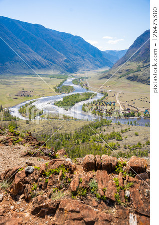 Chulyshman river winding through vast valley in Altai Russia seen from viewpoint near stone mushrooms Breathtaking Siberian landscape of mountains and flowing water 126475380