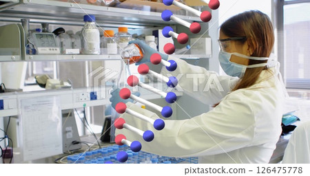 Image of dna strand and data processing over caucasian female scientist in laboratory 126475778