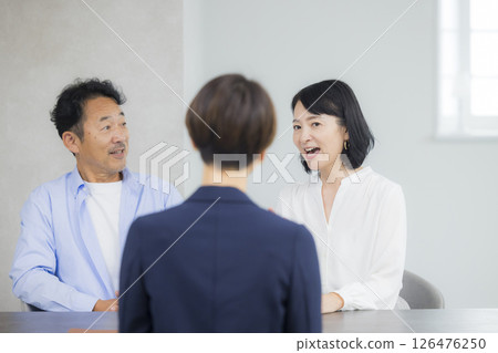 A middle-aged couple having a meeting A middle-aged couple having a meeting 126476250