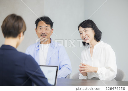 A middle-aged couple having a meeting 126476258