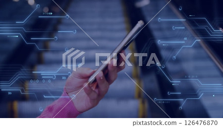 Image of computer circuit board over hand holding smartphone Image of computer circuit board over hand holding smartphone 126476870
