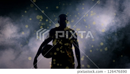 Image of light spots over african american male basketball player Image of light spots over african american male basketball player 126476890