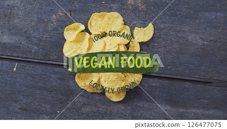 Potato chips on wooden surface with 100 percent Organic Vegan Food Locally Grown image 126477075