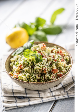 Traditional Tabouleh salad with bulgur, parsley, cucumber, tomato, coriander, garlic, mint and other ingredients Traditional Tabouleh salad with bulgur, parsley, cucumber, tomato, coriander, garlic, mint and other ingredients 126477226