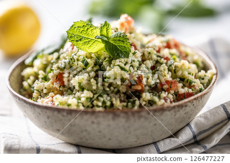 Traditional Tabouleh salad with bulgur, parsley, cucumber, tomato, coriander, garlic, mint and other ingredients Traditional Tabouleh salad with bulgur, parsley, cucumber, tomato, coriander, garlic, mint and other ingredients 126477227