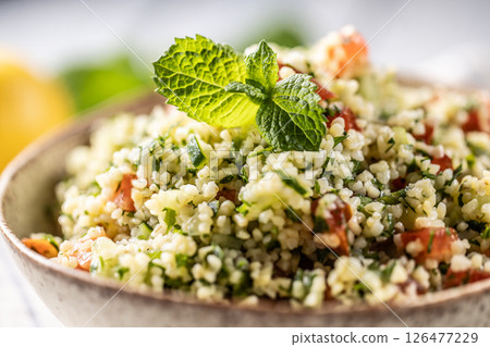 Traditional Tabouleh salad with bulgur, parsley, cucumber, tomato, coriander, garlic, mint and other ingredients 126477229