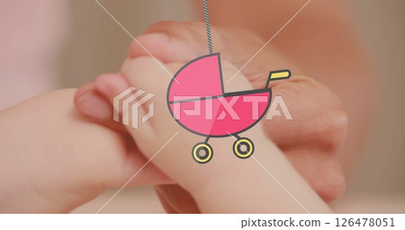 Image of hanging baby stroller over caucasian baby playing Image of hanging baby stroller over caucasian baby playing 126478051