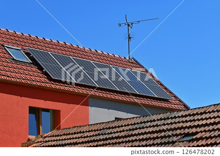 Family house with solar panels on the roof. Home photovoltaic power plant. Concept for industry and green cheaper electricity from renewable sources. Family house with solar panels on the roof. Home photovoltaic power plant. Concept for industry and green cheaper electricity from renewable sources. 126478202