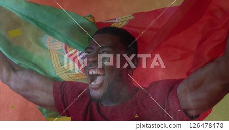 Image of confetti falling over african american male supporter with flag of portugal Image of confetti falling over african american male supporter with flag of portugal 126478478