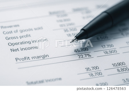 Macro Detail of Financial Report Balance Sheet with Fine Tip Pen Resting on Profit Margin Highlight 126478563