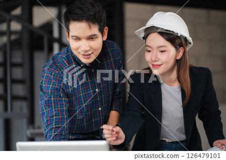 Engineering Team Collaborates on Blueprint Model in Corporate Office. 126479101