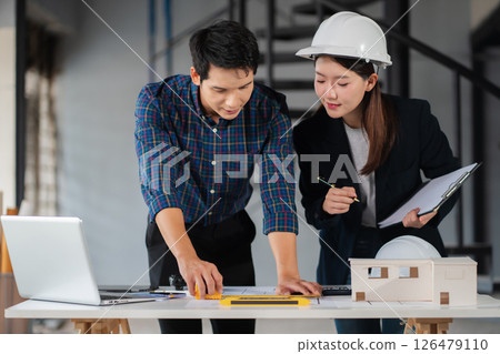 Engineer teams meeting working together wear worker helmets hardhat on construction site. Asian industry professional team. Engineer teams meeting working together wear worker helmets hardhat on construction site. Asian industry professional team. 126479110