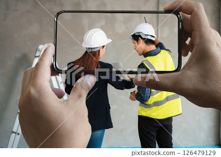 Businessman working as a team discussing data working and tablet, laptop with on on architectural project at construction site. Businessman working as a team discussing data working and tablet, laptop with on on architectural project at construction site. 126479129