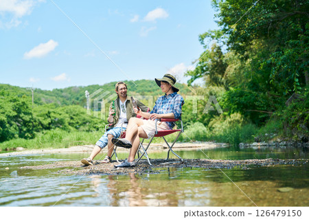 Two men cooling off in the river Two men cooling off in the river 126479150