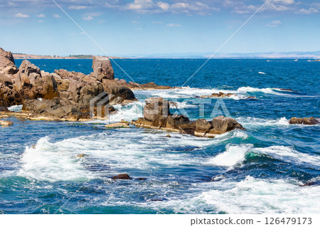 wave splashes on rocks at the black sea coast. summer vacations in europe. sozopol is a popular local travel destination of bulgaria. sunny day with blue sky 126479173