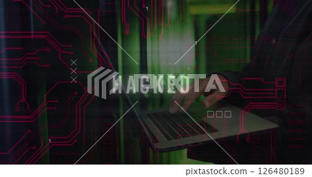 Typing on laptop, person over HACKED text and circuit board image 126480189