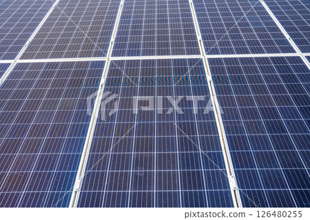 Close up of solar panels under bright sunlight with visible sun glare in Altai Russia Renewable energy technology in clean natural environment Close up of solar panels under bright sunlight with visible sun glare in Altai Russia Renewable energy technology in clean natural environment 126480255