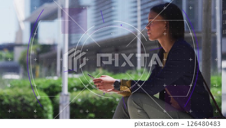 Image of scope scanning over biracial woman using smartphone in city 126480483