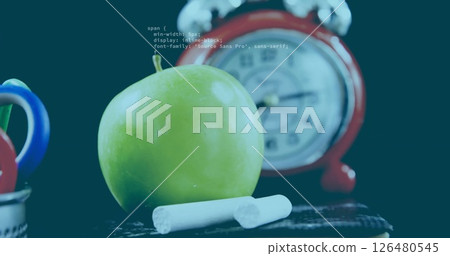 Green apple and chalk sticks with school supplies image over blurred clock background 126480545