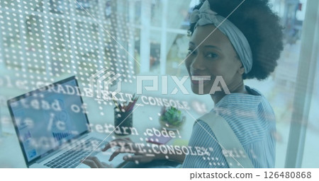 Image of financial data processing over african american businesswoman using laptop 126480868