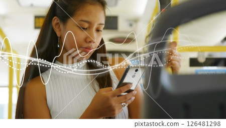 Image of diagram over biracial woman using smartphone in bus 126481298