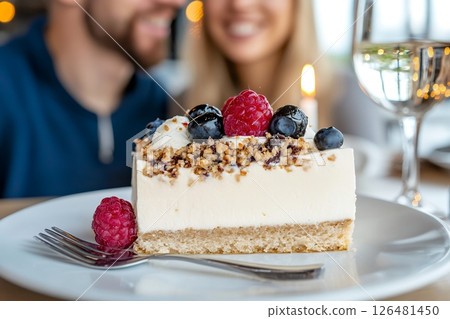 Delicious cheesecake with berries enjoyed by smiling caucasian couple Delicious cheesecake with berries enjoyed by smiling caucasian couple 126481450