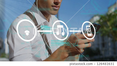 Holding smartphone, man with headphones and network connectivity image overlaid 126481631