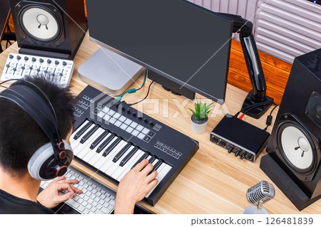 top view of asian man playing midi keyboard in home studio. music production or online music education concept  126481839