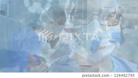 Scientists in laboratory wearing protective gear conducting research and experiments 126482795