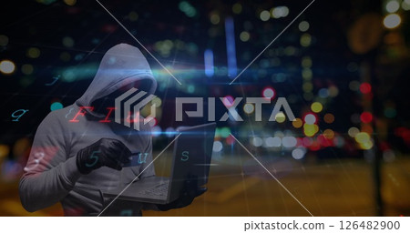 Hooded figure using laptop at night, digital interface overlay with city lights Hooded figure using laptop at night, digital interface overlay with city lights 126482900