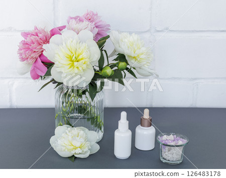 Spa products for facial and body care with peony flowers. Spa products for facial and body care with peony flowers. 126483178