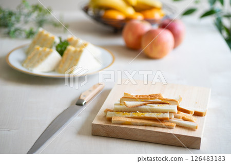 Bright kitchen scene with sandwiches being made, bread crusts 126483183