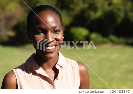 Smiling woman enjoying sunny day in garden, feeling relaxed and happy Smiling woman enjoying sunny day in garden, feeling relaxed and happy 126483577