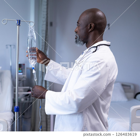 Doctor adjusting IV drip in hospital room, ensuring patient care and comfort Doctor adjusting IV drip in hospital room, ensuring patient care and comfort 126483619