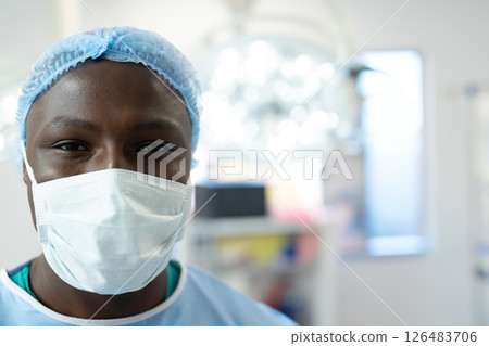 Healthcare professional wearing surgical mask and cap in hospital operating room, copy space 126483706