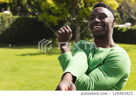 African American man stretching arms in park, smiling and enjoying sunny day, copy space African American man stretching arms in park, smiling and enjoying sunny day, copy space 126483825