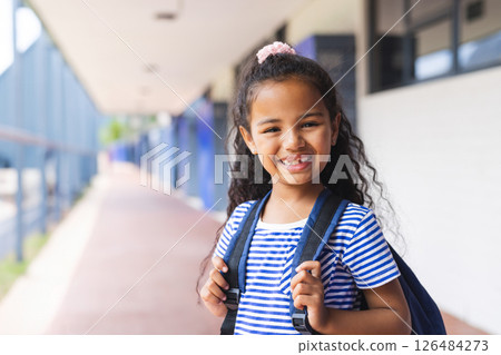 Smiling girl with backpack standing outside school, ready for new day, copy space Smiling girl with backpack standing outside school, ready for new day, copy space 126484273