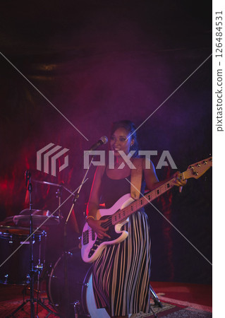 Musician playing electric guitar on stage, enjoying live performance with band, copy space 126484531
