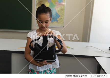 In school, child using virtual reality headset in classroom, exploring technology In school, child using virtual reality headset in classroom, exploring technology 126484548