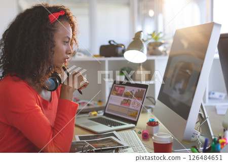 Creative woman working at desk with computer and laptop, focusing on design, copy space 126484651