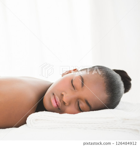 Woman relaxing at spa, resting peacefully on soft white towels, copy space Woman relaxing at spa, resting peacefully on soft white towels, copy space 126484912