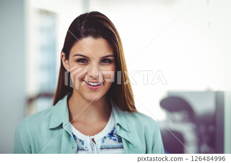 In office, businesswoman wearing casual attire, exuding confidence and positivity 126484996