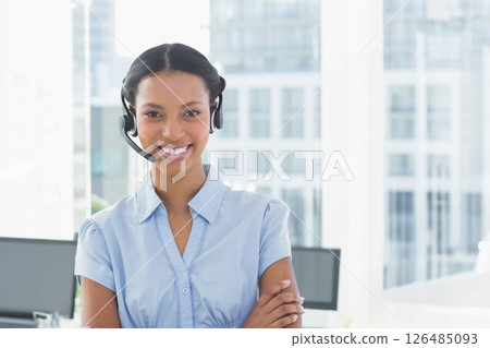 Wearing headset, businesswoman working in modern office, smiling while talking 126485093