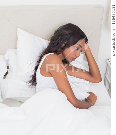 Relaxing in bed, woman reading book and sipping coffee in cozy bedroom Relaxing in bed, woman reading book and sipping coffee in cozy bedroom 126485151