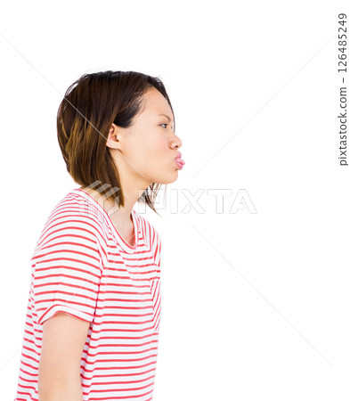 Asian woman in striped shirt playfully puckering lips, expressing fun mood 126485249