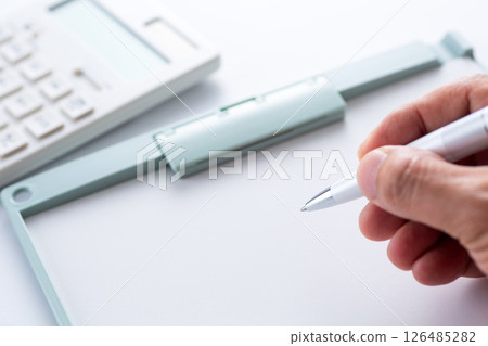 White calculator and binder 126485282